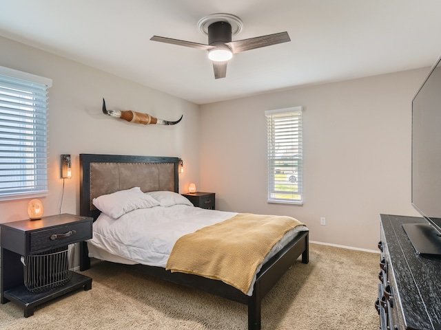 bedroom with light colored carpet and ceiling fan