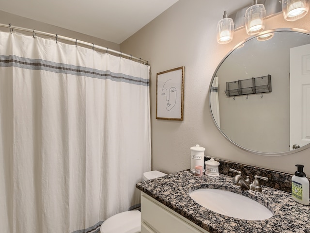 bathroom featuring toilet and vanity