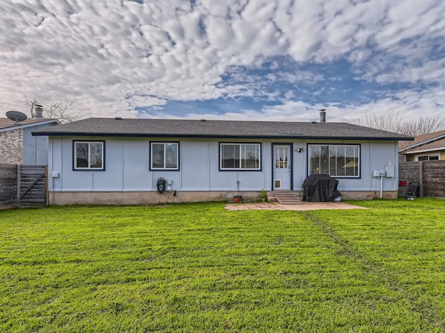 rear view of house with a yard