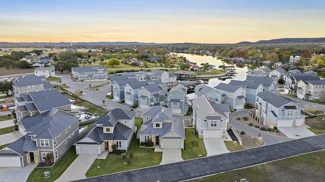 aerial view at dusk with a water view