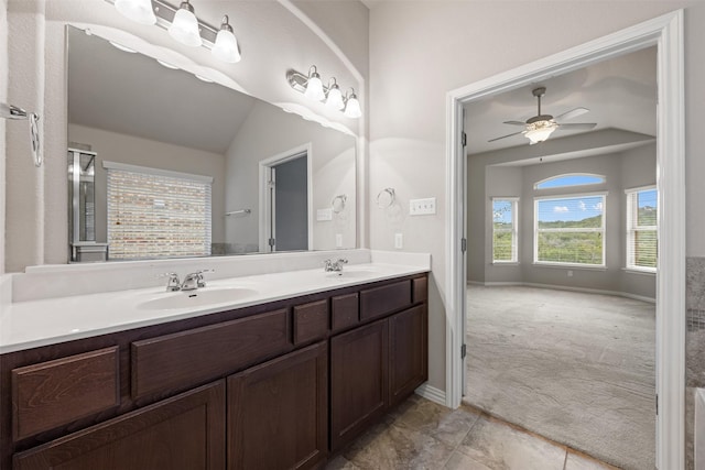 bathroom featuring ceiling fan, vanity, and lofted ceiling