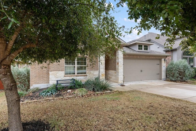 obstructed view of property featuring stone siding, driveway, and an attached garage