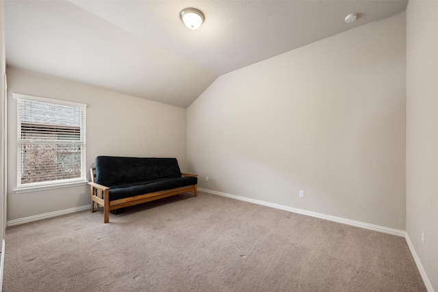 living area with vaulted ceiling and light carpet