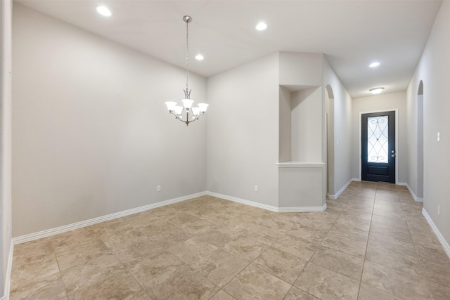 foyer entrance featuring an inviting chandelier