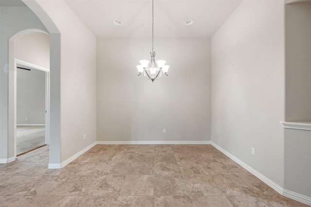 empty room featuring a chandelier