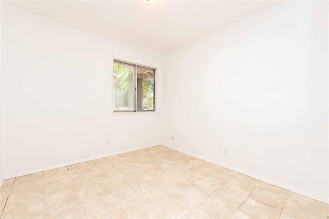 unfurnished room featuring baseboards