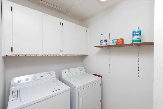 laundry area featuring washing machine and dryer and cabinet space