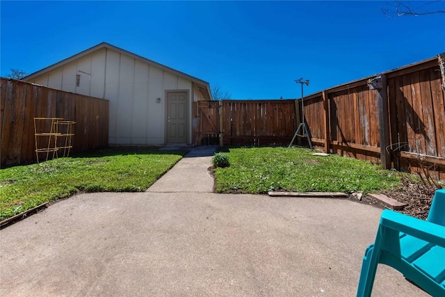 view of yard featuring a patio, a gate, and a fenced backyard