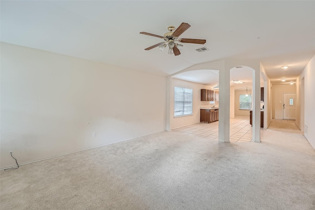 unfurnished living room with ceiling fan and light colored carpet