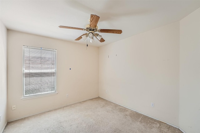 empty room with ceiling fan and light colored carpet