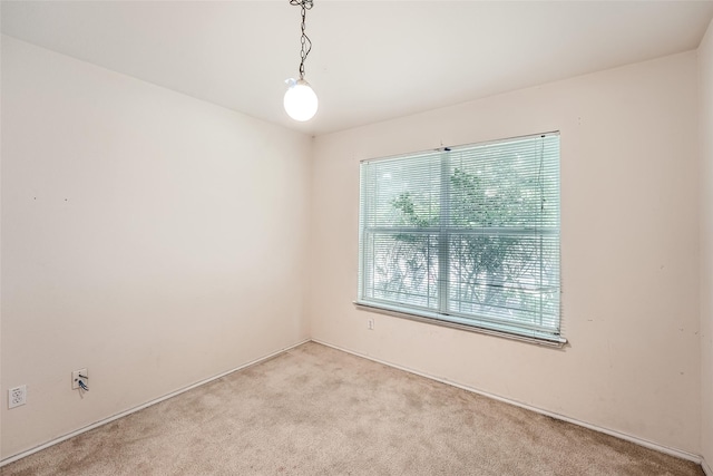 unfurnished room with light colored carpet