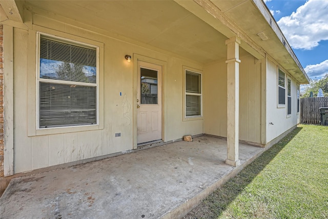 view of exterior entry with a patio