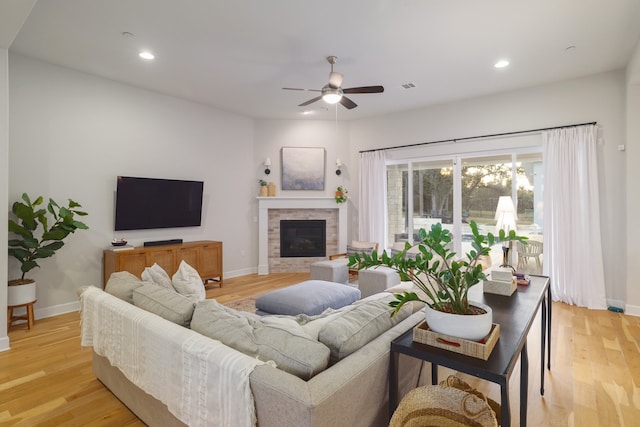 living room with light wood-type flooring and ceiling fan