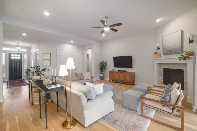 living room with ceiling fan and light wood-type flooring