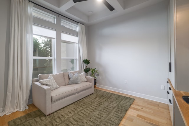 living area with coffered ceiling, light hardwood / wood-style flooring, and ceiling fan