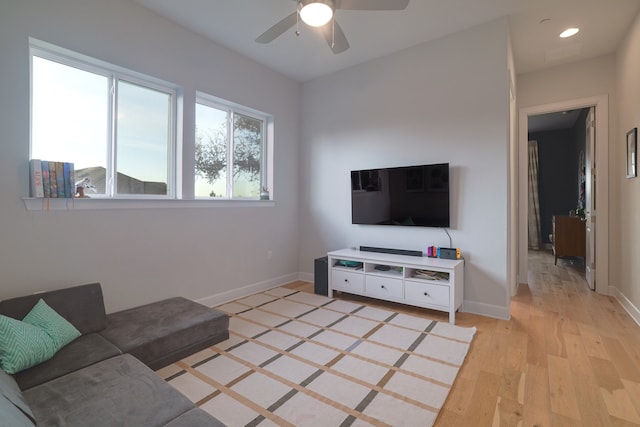 living room featuring ceiling fan and light wood-type flooring