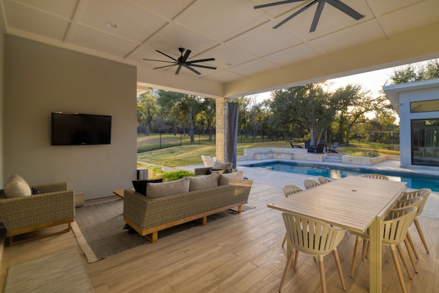 view of swimming pool with ceiling fan, outdoor lounge area, and a patio area