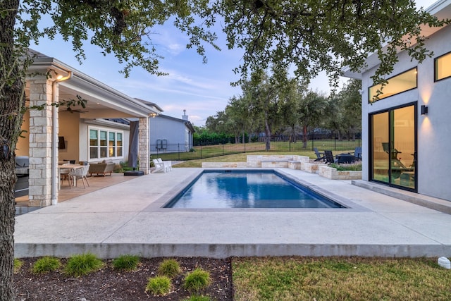 view of swimming pool featuring a patio area and ceiling fan