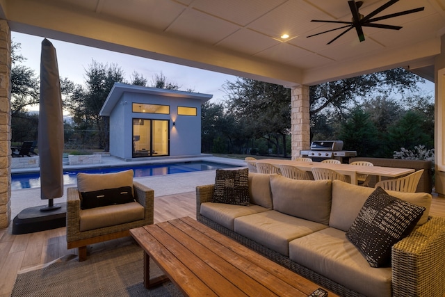 view of patio featuring ceiling fan, outdoor lounge area, a grill, and an outbuilding