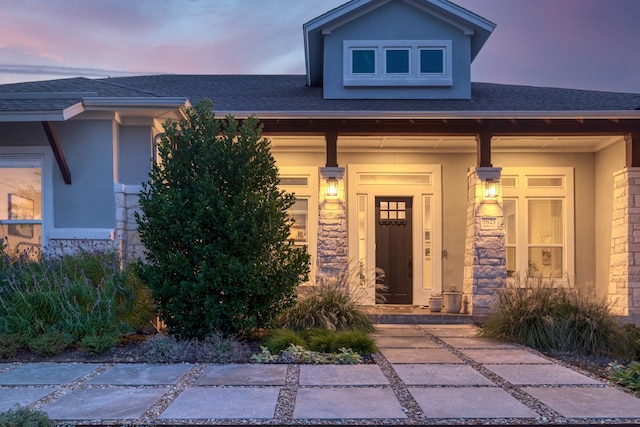 view of exterior entry at dusk