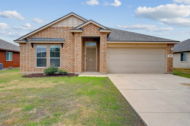 view of front of property featuring brick siding, a garage, driveway, and a front lawn