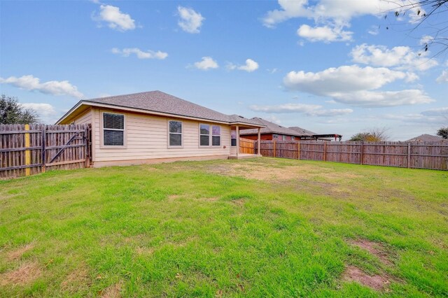 rear view of house with a lawn