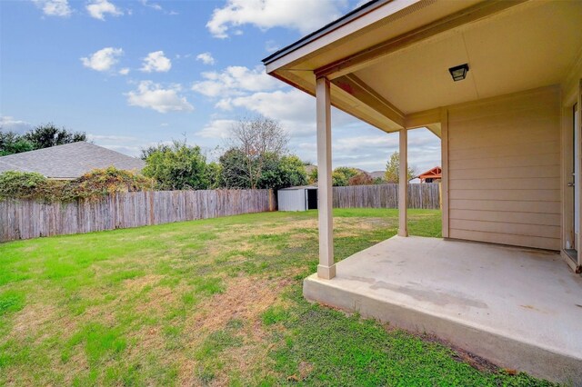 view of yard with a storage unit and a patio