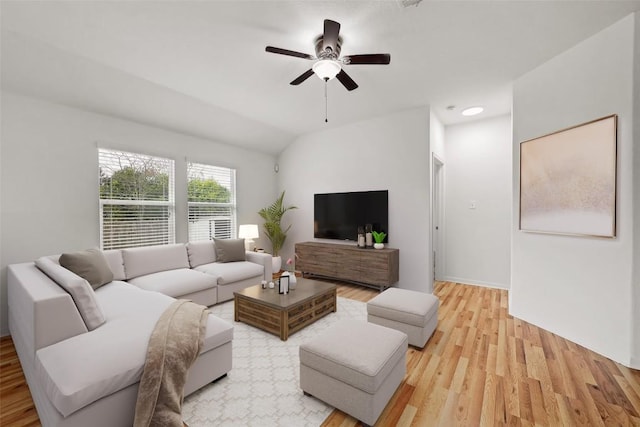 living area with lofted ceiling, baseboards, light wood finished floors, and ceiling fan