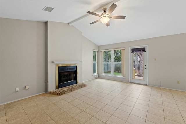 unfurnished living room with ceiling fan, light tile patterned floors, lofted ceiling with beams, and a fireplace