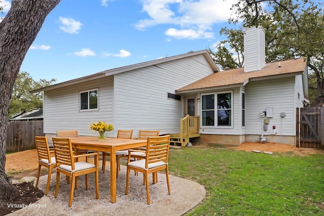 rear view of house featuring a yard and a patio