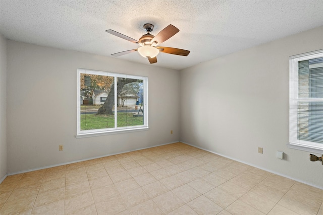 spare room featuring ceiling fan and a textured ceiling