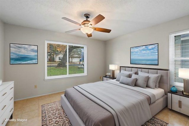 tiled bedroom with a textured ceiling and ceiling fan