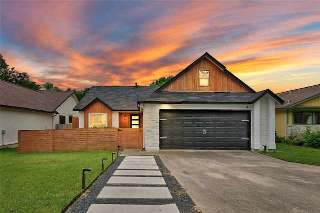 view of front of house featuring a yard and a garage