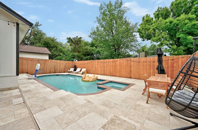 view of pool featuring an in ground hot tub and a patio