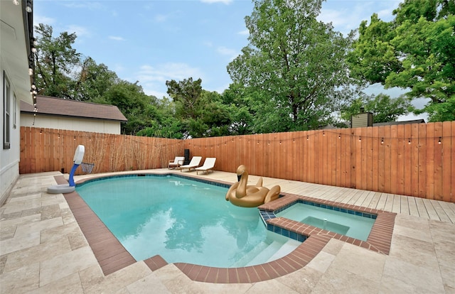 view of pool featuring an in ground hot tub and a patio area