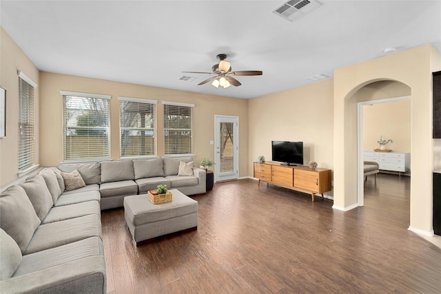 living room with dark hardwood / wood-style floors and ceiling fan