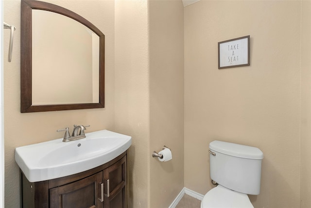 bathroom with toilet and vanity