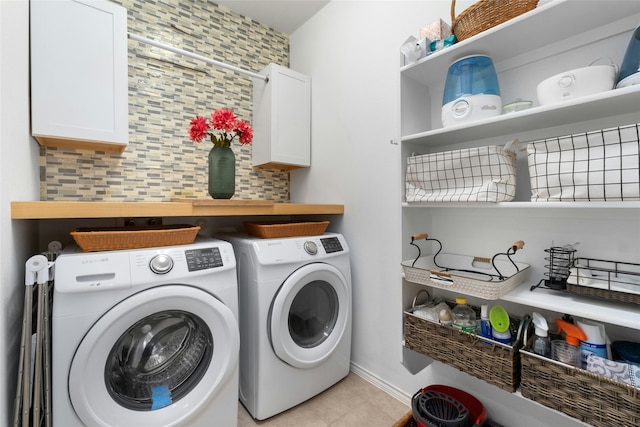 laundry room with cabinets, separate washer and dryer, and light tile patterned flooring