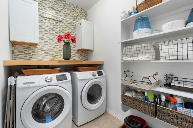 9201 Bentley Garner Ln, Austin, TX 78748 - washroom with cabinet space, washer and clothes dryer, and light tile patterned floors