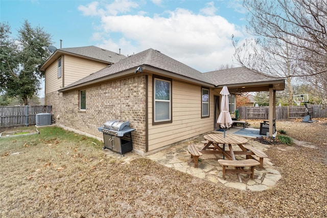 rear view of house with central air condition unit and a patio area