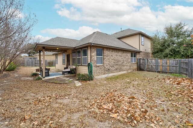 9201 Bentley Garner Ln, Austin, TX 78748 - rear view of property with a patio area, brick siding, a fenced backyard, and roof with shingles