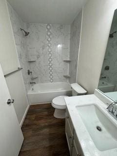 full bathroom with tiled shower / bath combo, hardwood / wood-style flooring, toilet, and vanity