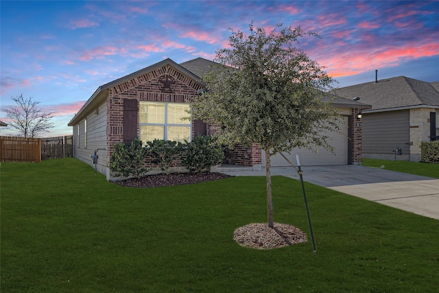 view of front of property with a garage and a yard