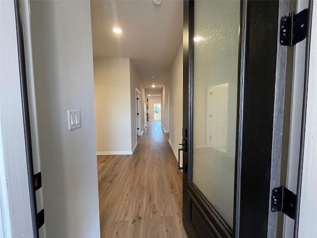 corridor featuring light hardwood / wood-style floors