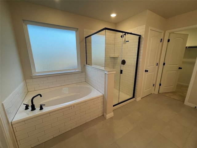 bathroom with shower with separate bathtub