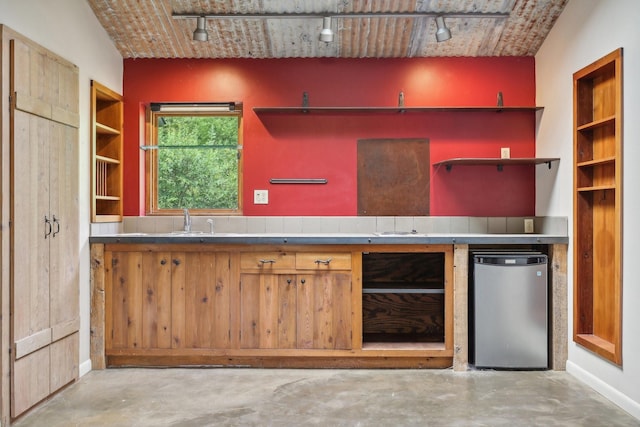 kitchen with track lighting, sink, refrigerator, and lofted ceiling