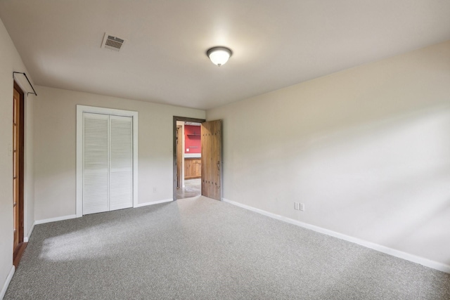 unfurnished bedroom featuring a closet and carpet floors