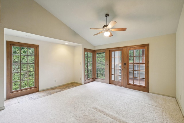 spare room with ceiling fan, light colored carpet, high vaulted ceiling, and a healthy amount of sunlight