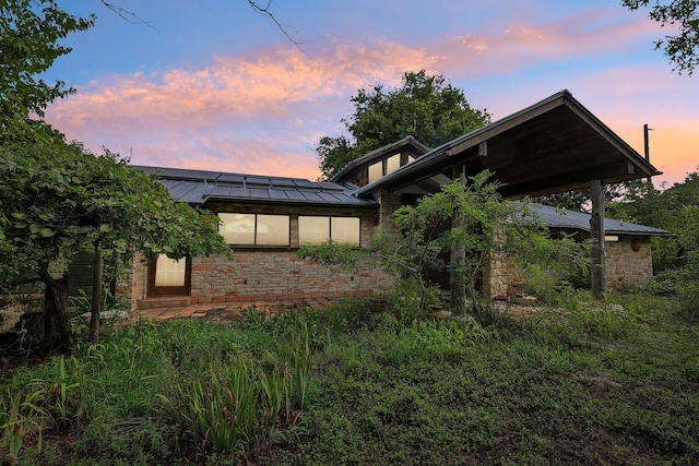 view of back house at dusk