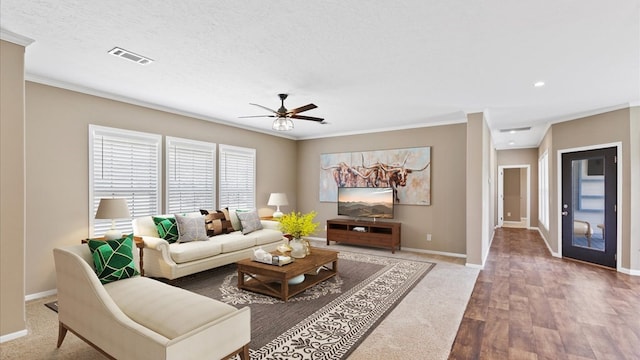 living room featuring crown molding, hardwood / wood-style flooring, a textured ceiling, and ceiling fan